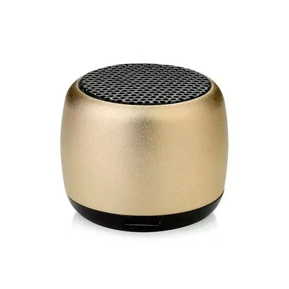 Gold-colored cylindrical portable bluetooth speaker with black mesh top and base for outdoor subwoofer speaker use