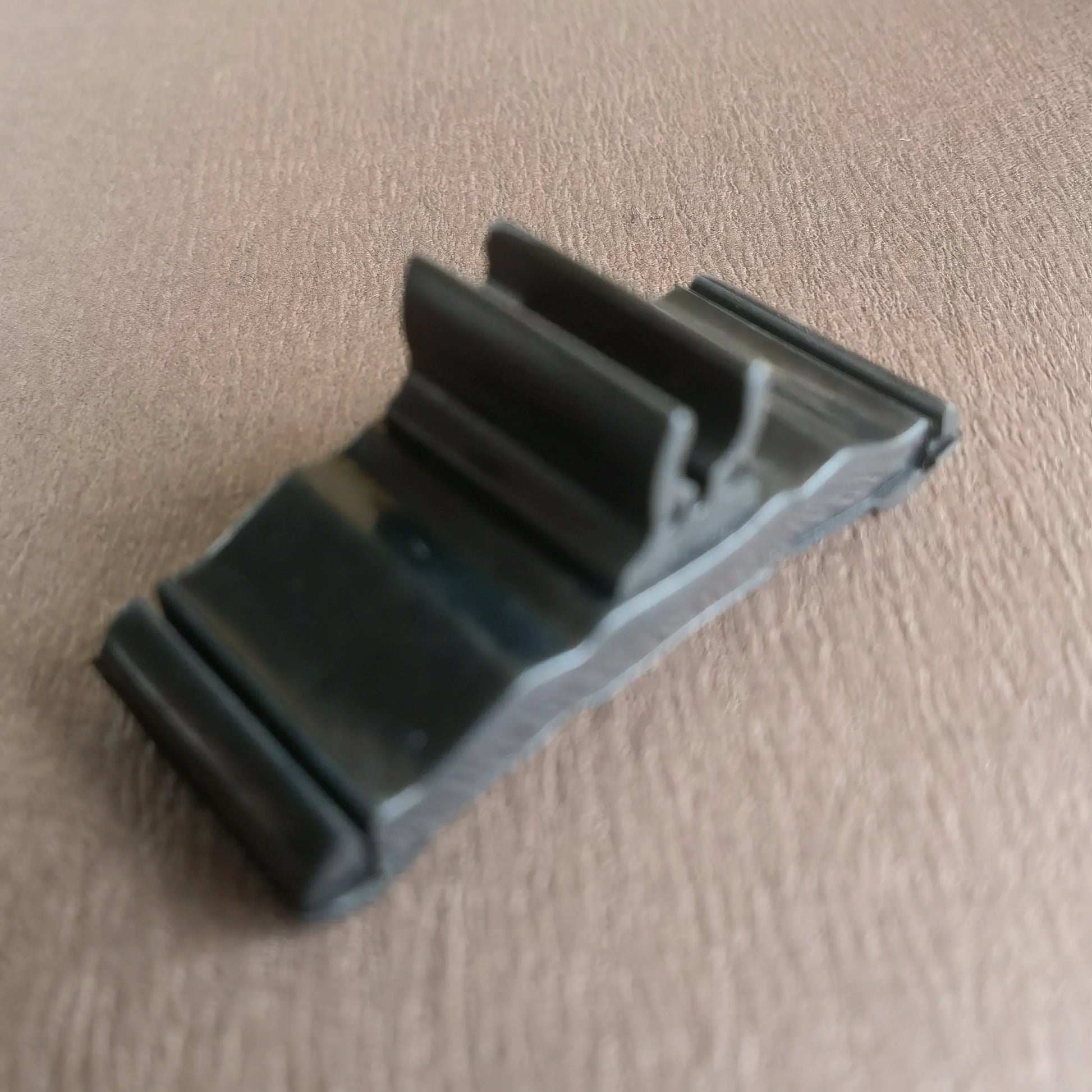 Black rubberized plastic m100b professional bass microphone clip with textured grip and molded design for secure attachment