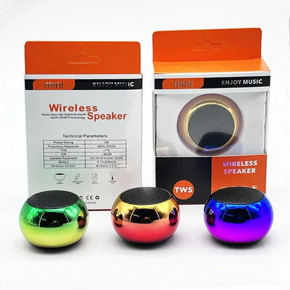 Three colorful spherical mini wireless bluetooth speakers in green gold and purple with glossy metal finishes