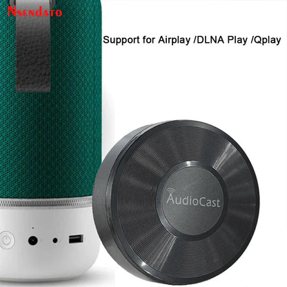 Green textured fabric music audio speaker with white base and black audiocast wireless dlna airplay adapter spotify streamer