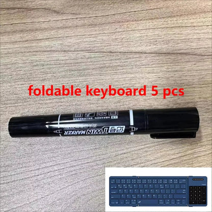 Black dual-tip marker with white labeling and clip beside the manchez e4 e7 mini channel sound card mixer console dj karaoke