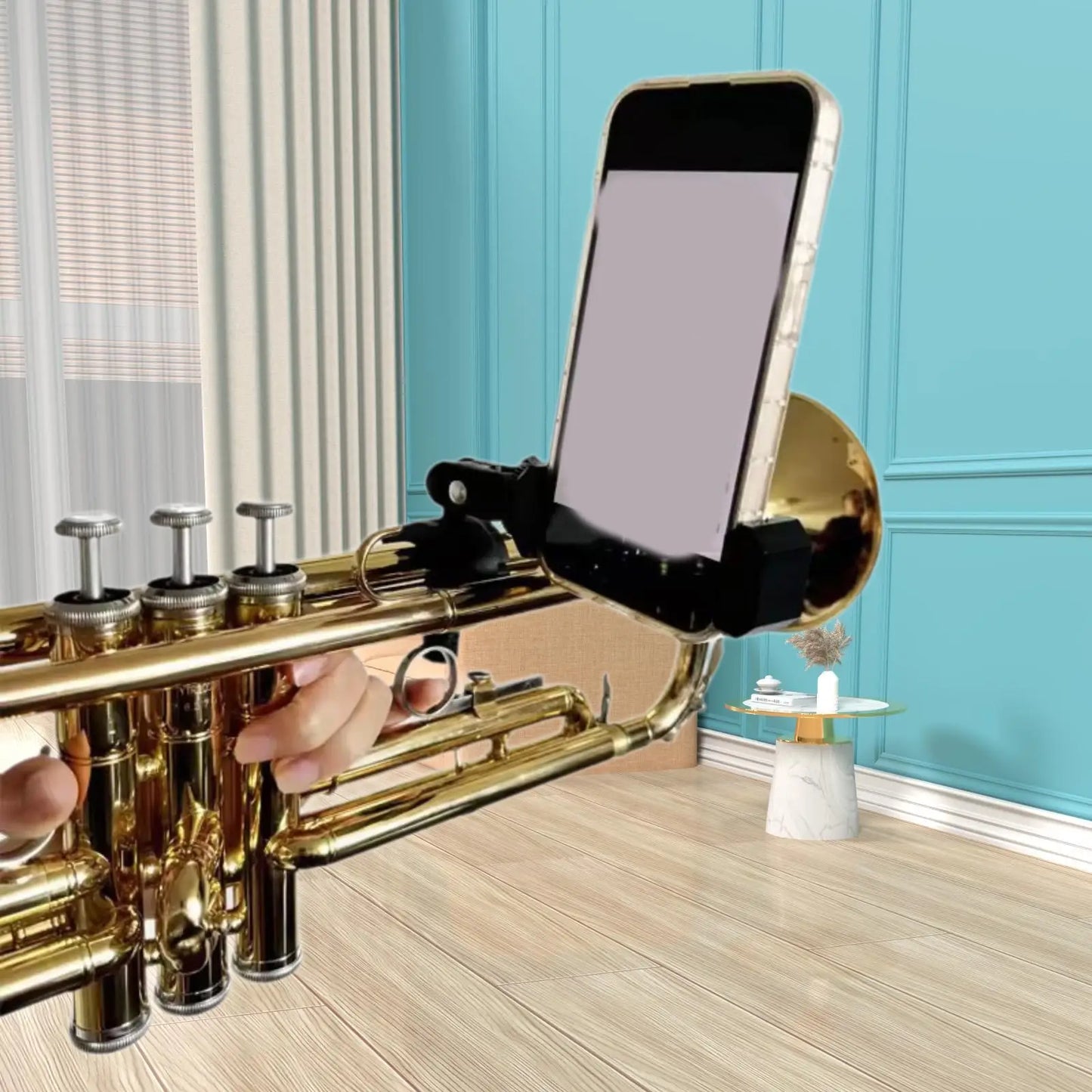 Gold-colored brass trumpet with adjustable sturdy black lyre phone holder for marching band music pdf reading