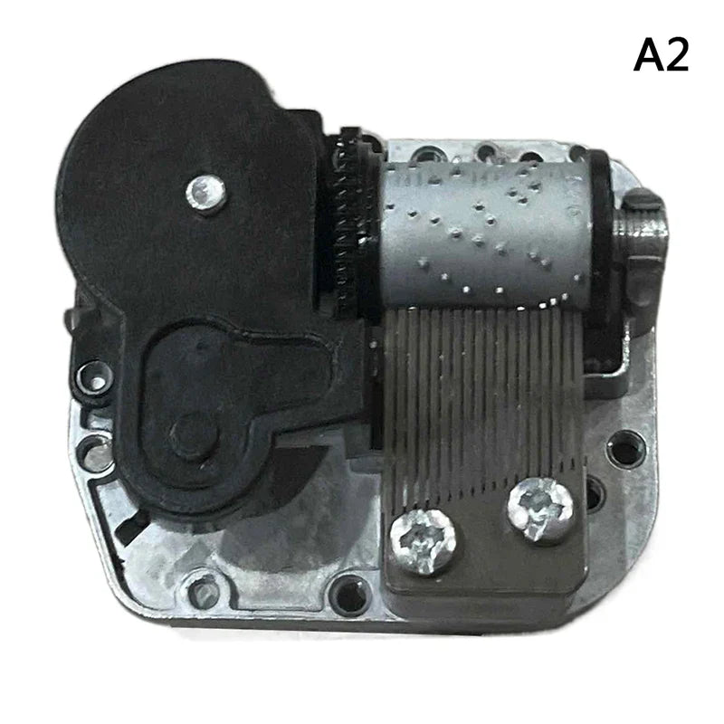 Silver and black mechanical diy windup music box sankyo with textured cylinder visible gears screws and winding key