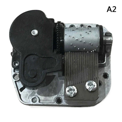 Silver and black mechanical diy windup music box sankyo with textured cylinder visible gears screws and winding key
