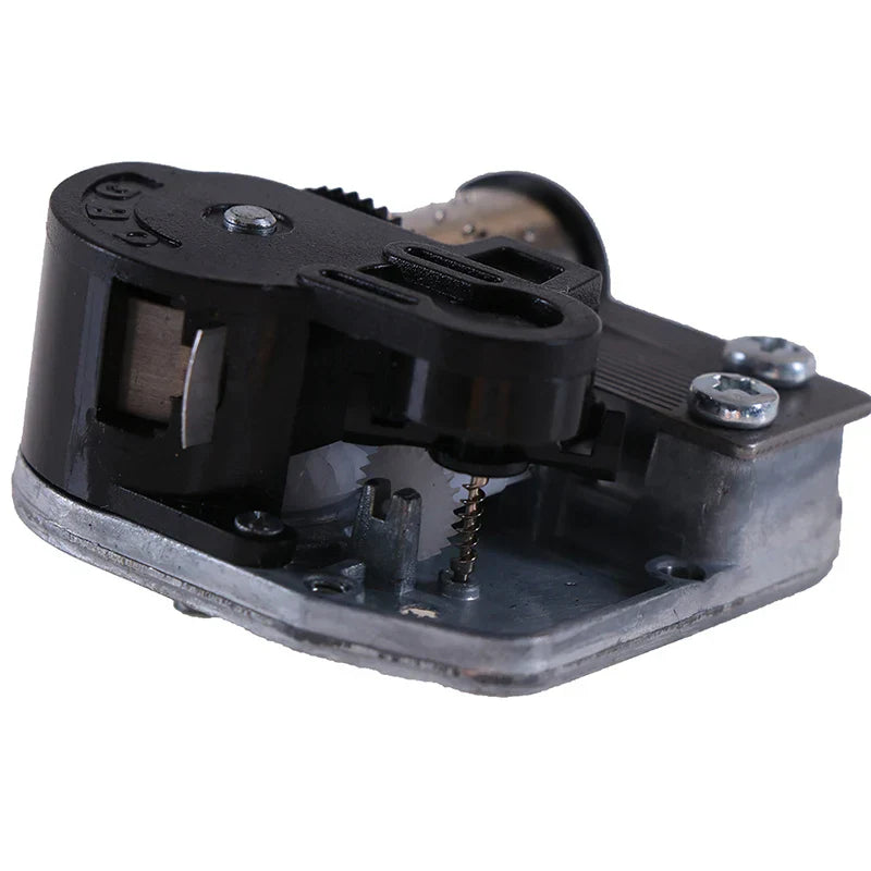 Black plastic and metal mechanical diy windup music box sankyo with visible gears springs screws and key mechanism
