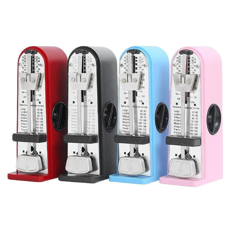 Four colorful mechanical metronome piano devices in red black blue and pink with metallic faces and adjustable mini beater guitar tempo markings
