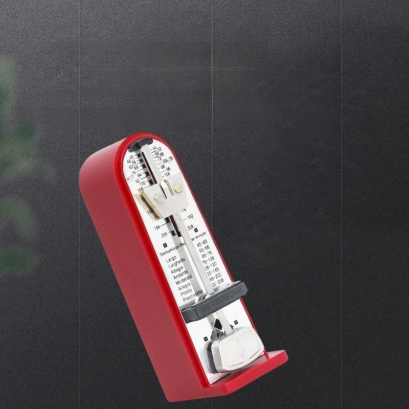 Red mechanical metronome piano with metallic silver interior and black tempo markings for mini beater guitar and guzheng rhythm device