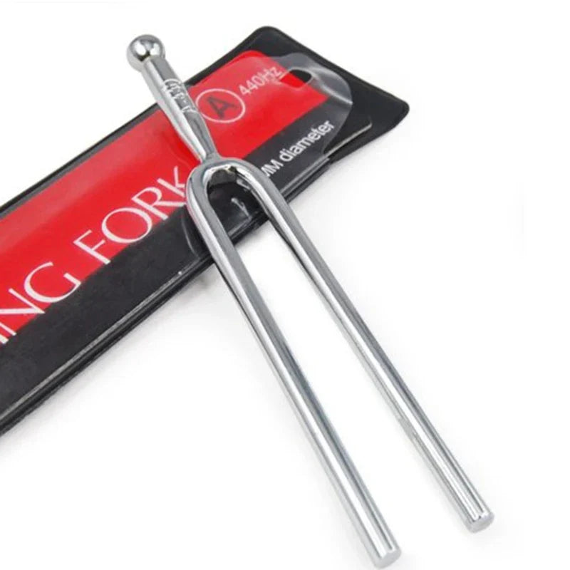 A sleek silver stainless steel tuning fork 440hz with two prongs and rounded handle for hammer healing sound and percussion