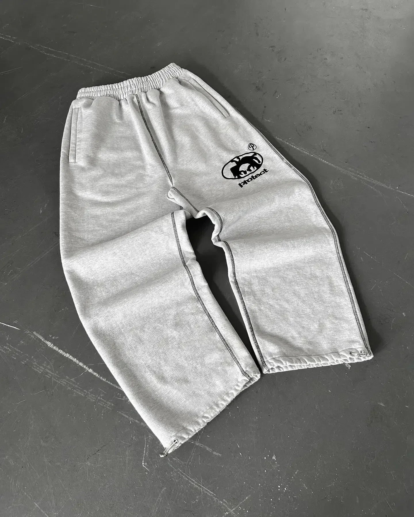 Men tracksuit gray sweatpants with loose fit korean design and black embroidered logo for american style y2k streetwear