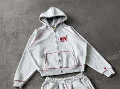 A light gray men tracksuit gray with red stitching loose fit korean style featuring a cropped hoodie and matching sweatpants