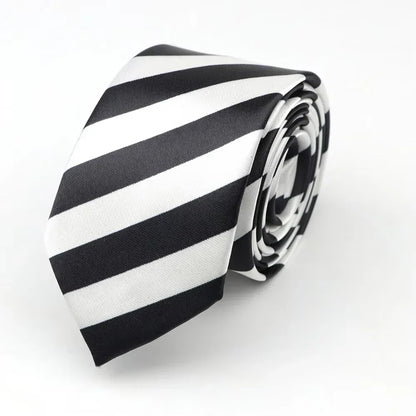 A sleek black and white classic skinny tie in printed piano polyester, neatly rolled for party or cosplay use