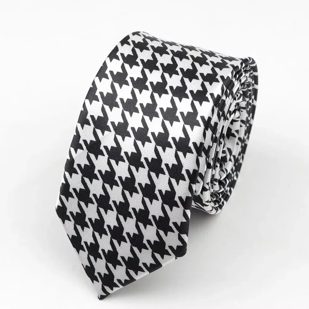 A sleek black and white houndstooth classic skinny tie made from smooth satin polyester perfect for formal occasions