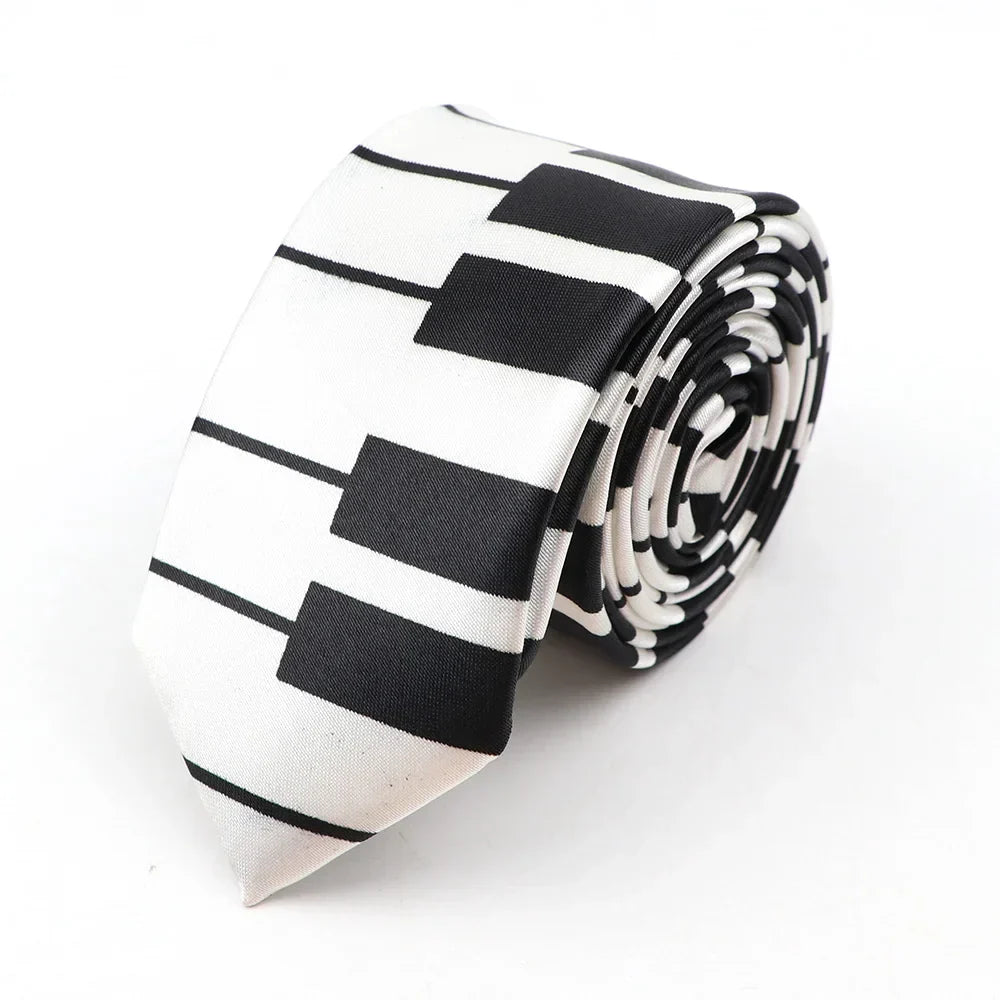 A sleek black and white printed piano polyester classic skinny tie with colorful musical notes neatly rolled for display