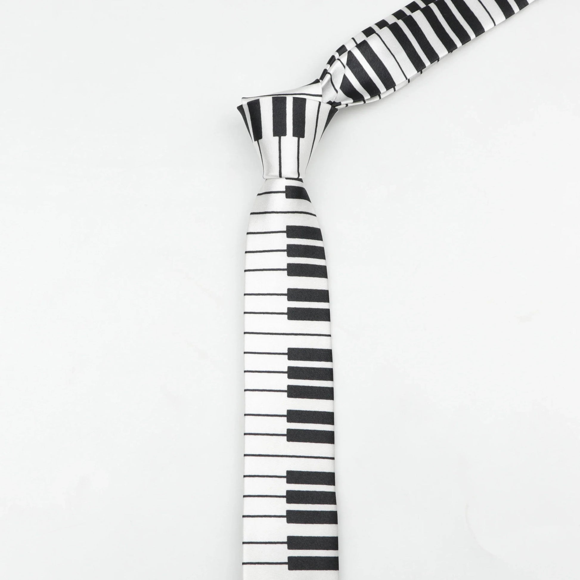 A sleek classic skinny tie with black and white printed piano polyester design and a smooth satin finish