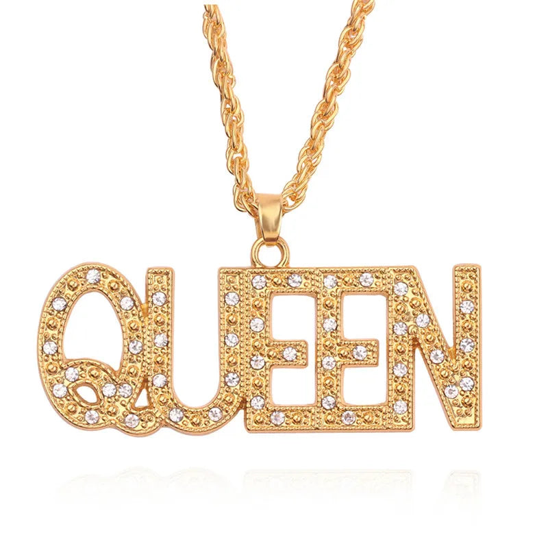 Gold queen pendant necklace with clear rhinestones on letters hanging from a matching gold hip hop king cuban link chain