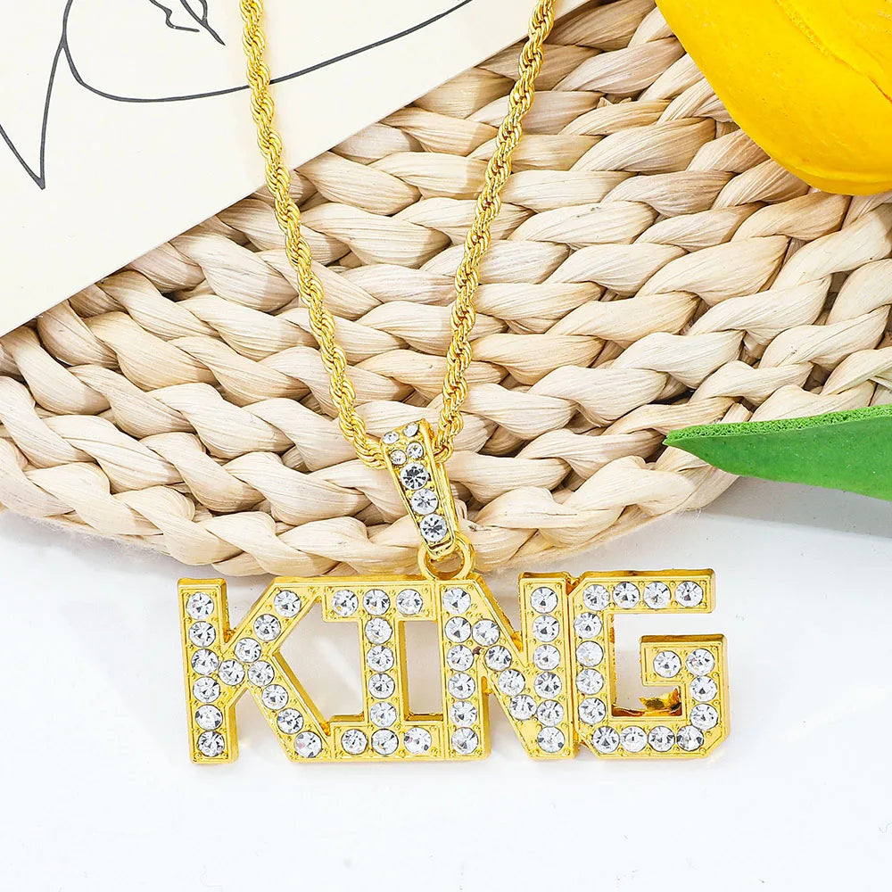 Gold-colored hip hop king pendant necklace with clear rhinestones on letters and matching cuban link chain