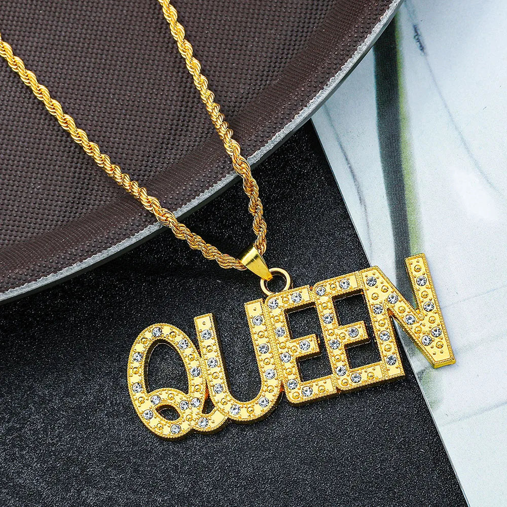 Gold-colored queen pendant necklace with clear rhinestones and twisted rope chain on a hip hop king cuban link chain
