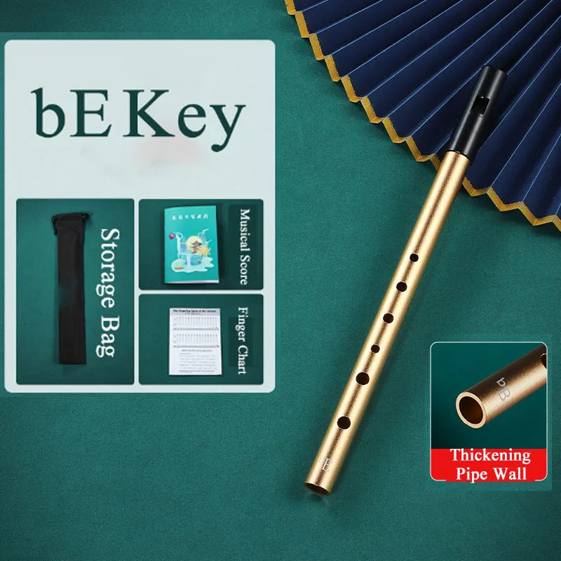 Gold-colored metal irish whistle with black mouthpiece and thickened pipe wall for student playing recorder and professional performance irish use