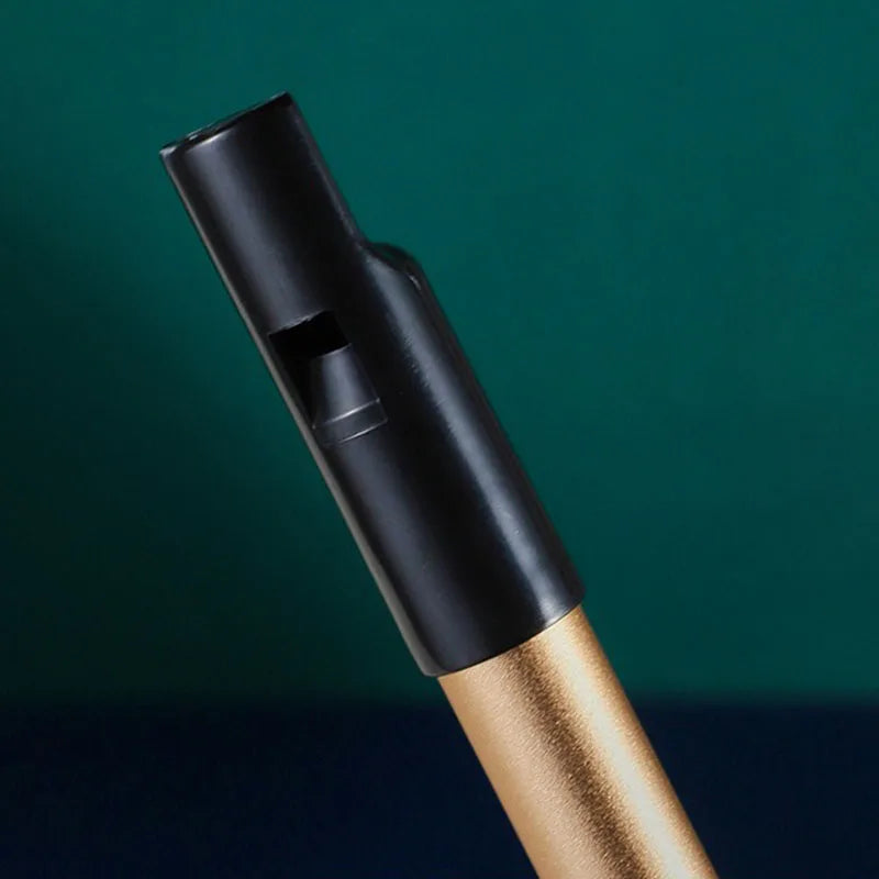 Black plastic metal irish whistle with gold metallic stem for student playing recorder and professional performance irish use