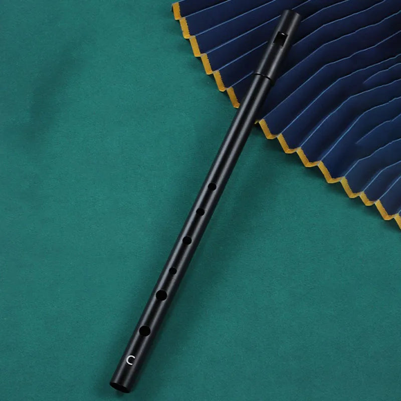 Black metal irish whistle with seven finger holes and a c marking for student playing recorder and professional performance irish use