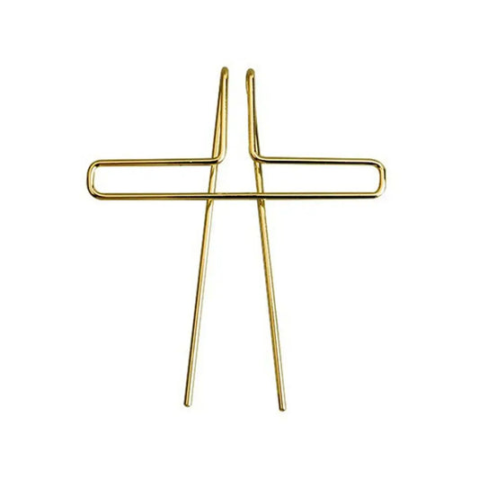 Gold-colored metal music book clip shaped as a cross for page holder pianos and cooking recipe magazines