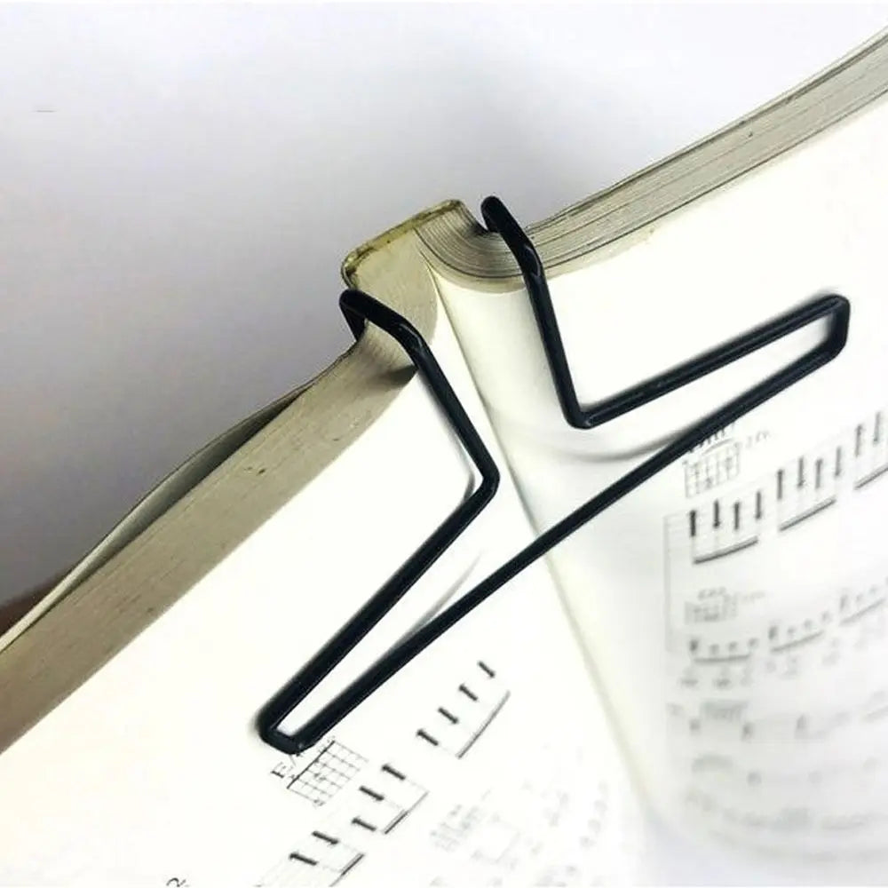 Black metal music book clip with hollow out design holding open a music score for page holder pianos and cooking recipe magazines