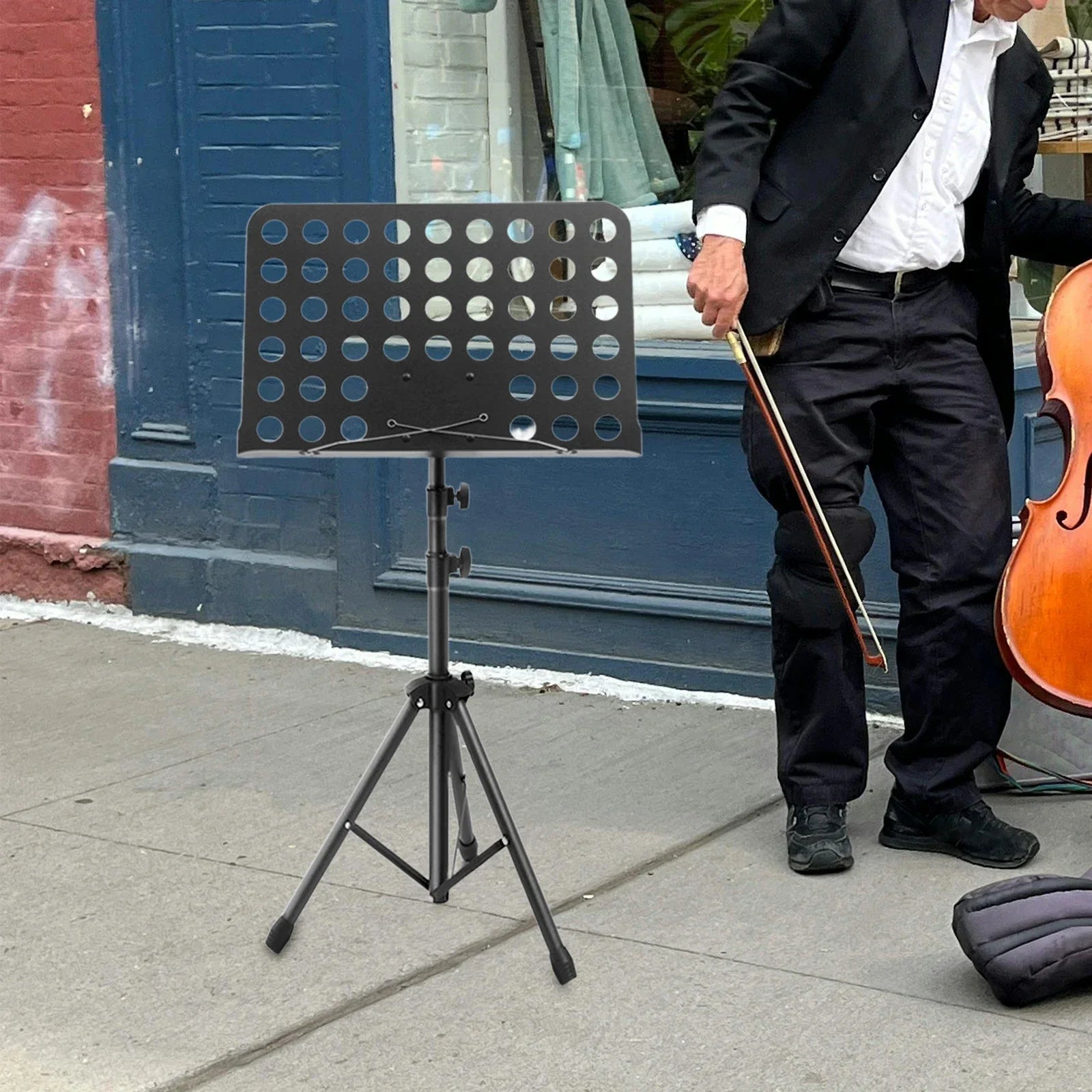 Black metal music stand with circular cutouts and adjustable tripod legs for guitar violin ukulele and piano desk stand use