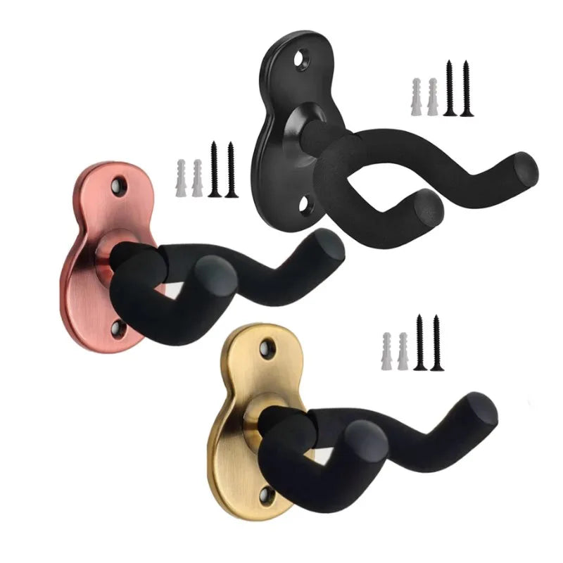 Set of three metal wall mount guitar hangers in black, rose gold, and brass finishes for acoustic electric guitars