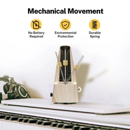 A mechanical metronome accurate for beginners made of ash wood grain with a black and gold face and brass knobs to track beat tempo