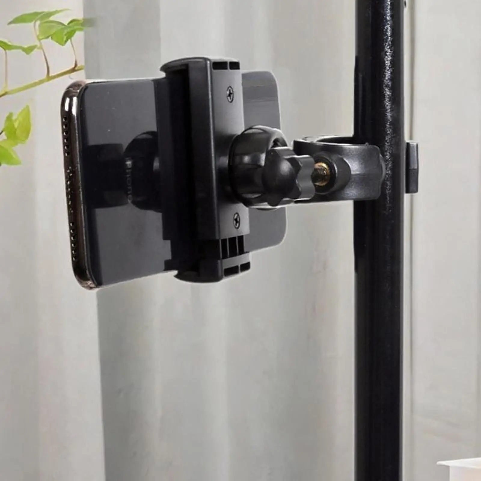 Black plastic mic stand phone holder with adjustable arm and clamp securing smartphone for live broadcast riding and drums adjustable easy setup