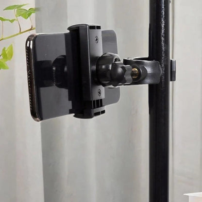 Black plastic mic stand phone holder with adjustable arm and clamp securing smartphone for live broadcast riding and drums adjustable easy setup
