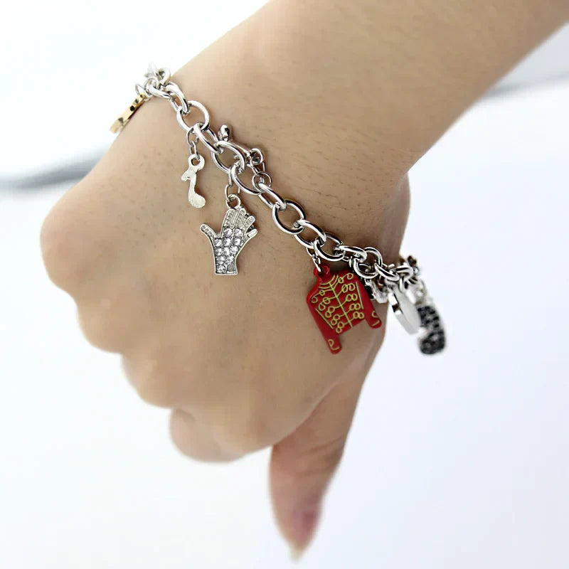 Silver music charm bracelet featuring a hand-shaped pendant with clear stones and a red gold-embroidered charm, michael jackson music arrival infinity bracelet
