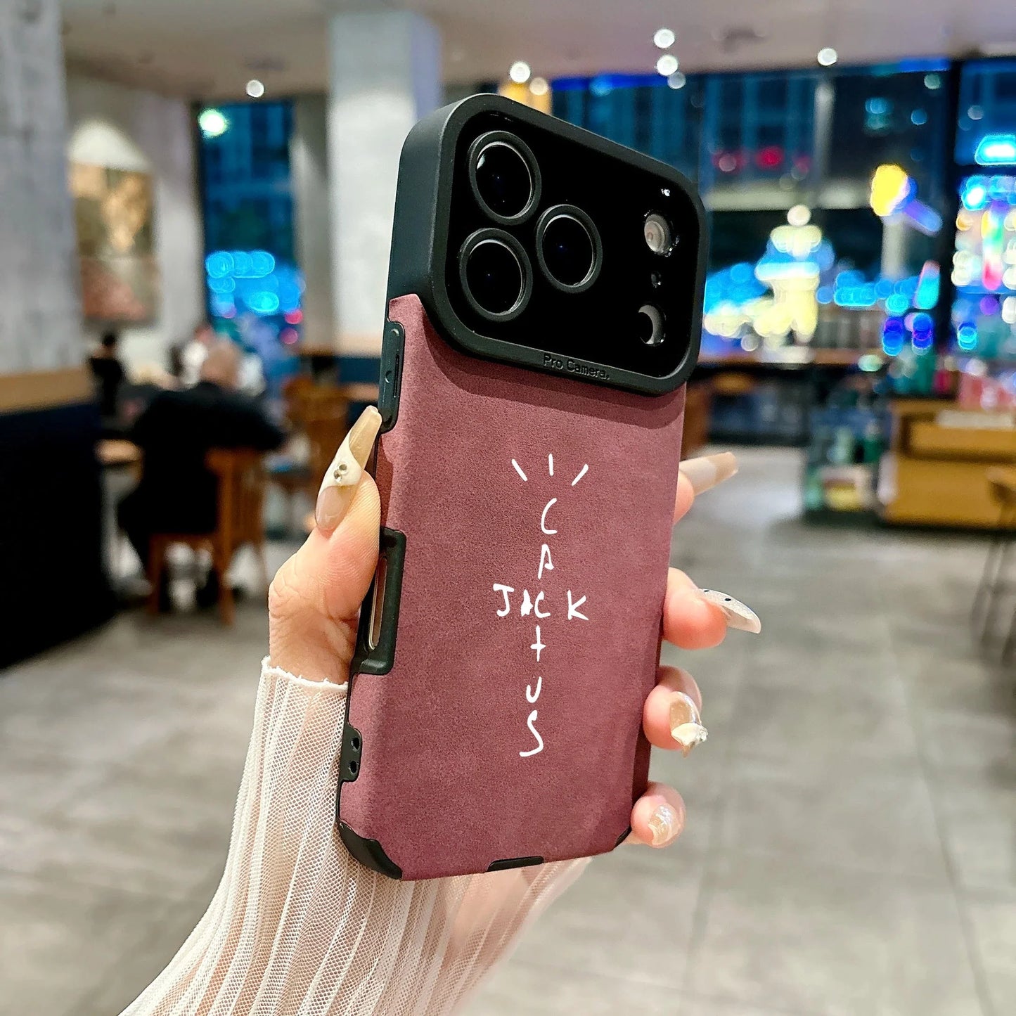 Back view of a maroon microfiber leather phone case with black camera bump and white cactus lettering cover 16e luxury