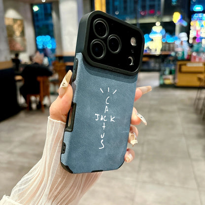 Back side of blue suede-textured microfiber leather phone case with black camera bump and white cactus jack lettering cover 16e luxury music jack cases