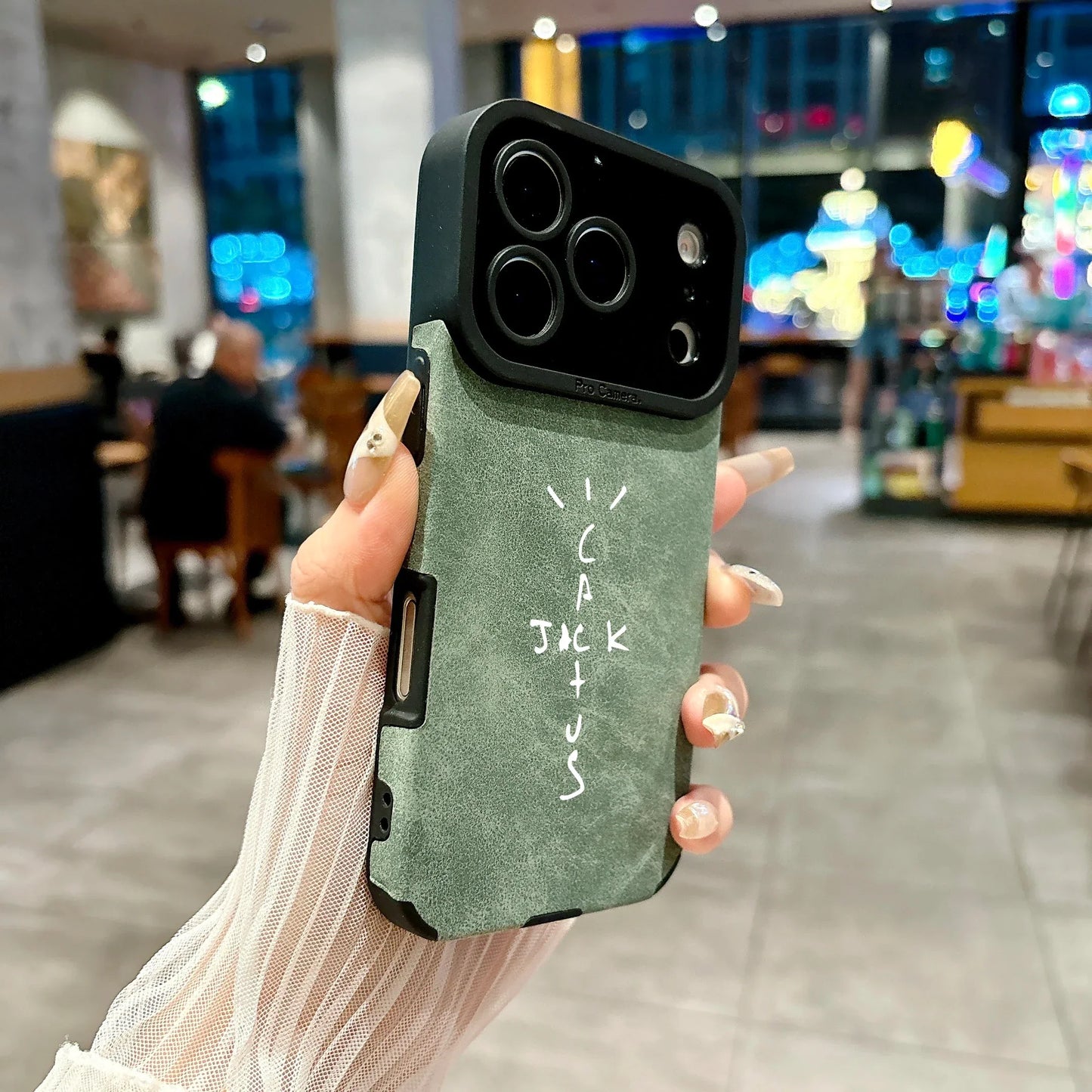 Matte sage green microfiber leather phone case back with black camera bump and white cactus jack lettering cover 16e luxury music jack cases