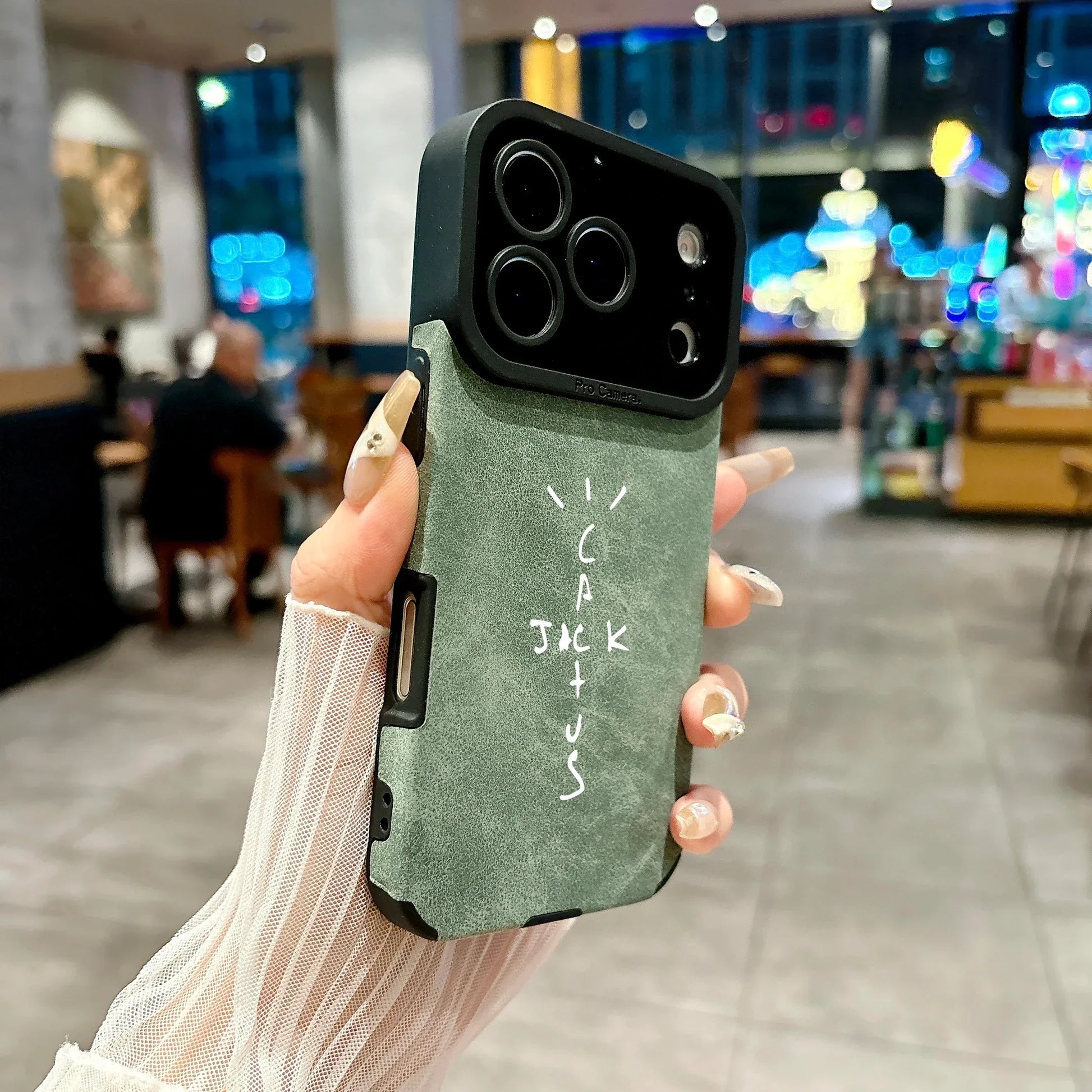 Matte sage green microfiber leather phone case back with black camera bump and white cactus jack lettering cover 16e luxury music jack cases