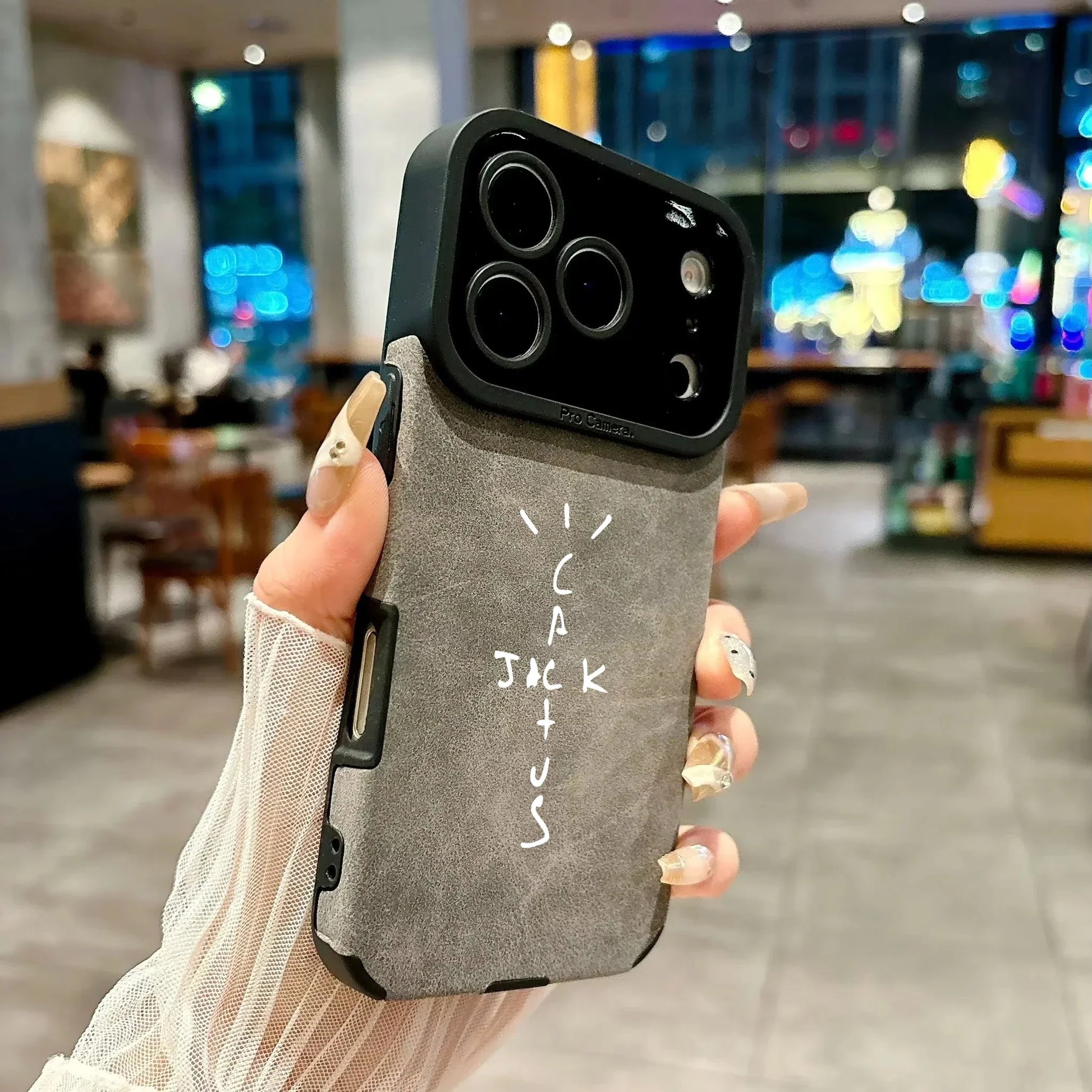 Back side of gray microfiber leather phone case with black camera cutout and white cack jac plus us lettering for cover 16e luxury music jack cases