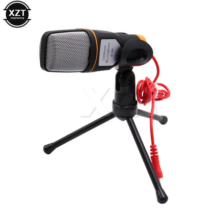 Black and orange condenser microphone with silver mesh grille on tripod stand for professional sound podcast studio use