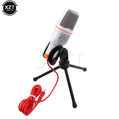 White and orange condenser microphone professional sound with silver mesh grille on black tripod stand for laptop skype singing