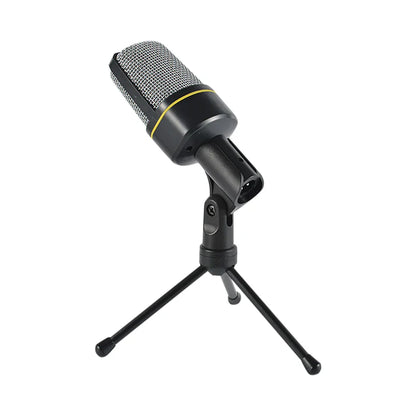 Black jack recording condenser microphone with silver mesh grille and yellow accent on mini tripod mount for laptop singing