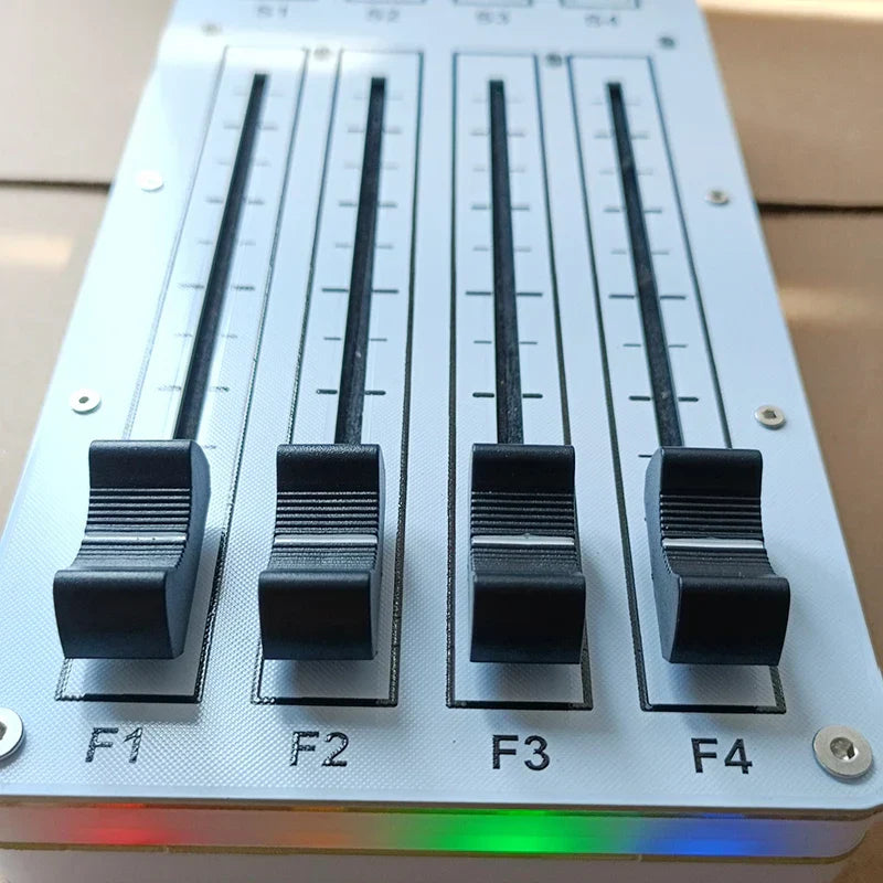 White midi cc controller with four black sliding faders and rainbow led strip for computer music hosting software