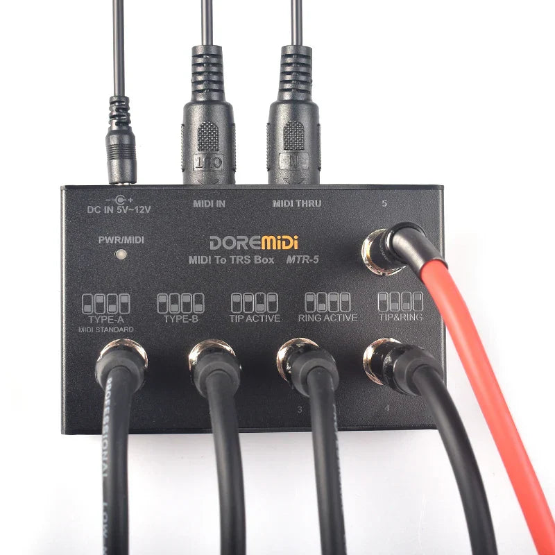 Black doremidi mtr-5 trs interface convert box showing five-pin din interface and multiple trs output jacks connected cables
