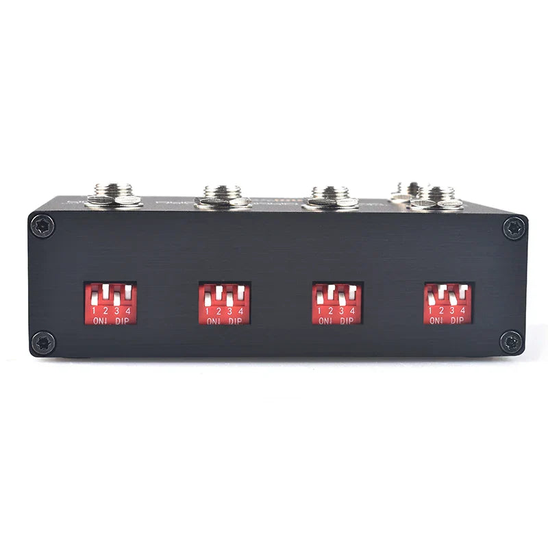 Black rectangular midi thru to trs box with four red toggle switches and silver connectors to convert midi five-pin din interface into trs outputs