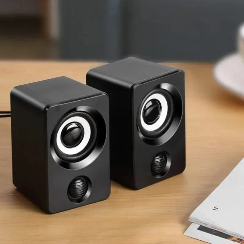 Black cube-shaped mini computer speaker usb wired with circular drivers and glossy finish for sound surround portable use
