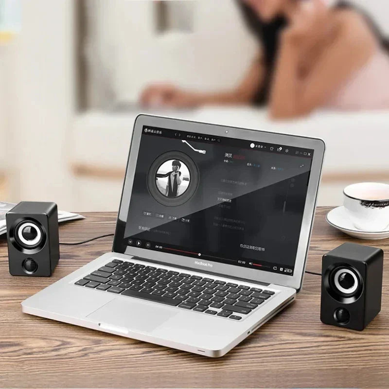 Silver laptop with black keyboard featuring mini computer speaker usb wired sound surround portable speakers