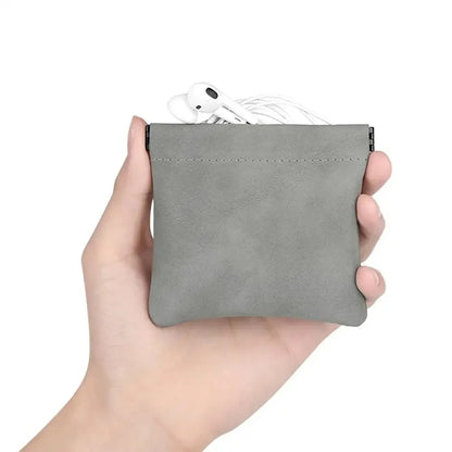 Gray suede earphone storage bag holding white apple airpods with pocket waterproof dustproof design for accessories organization