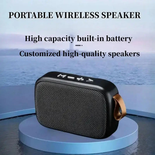 Black mini fabric portable wireless speaker with textured grille and tan leather strap for indoor outdoor use