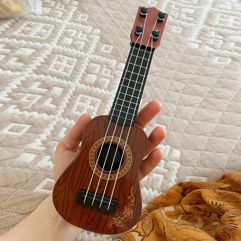 Miniature wooden classical ukulele guitar with reddish-brown finish and gold inlay for kids children beginners