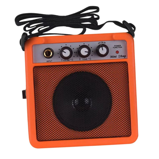 Bright orange mini guitar amplifier 5w small speaker with black grille and volume control for electric guitar at beat music store