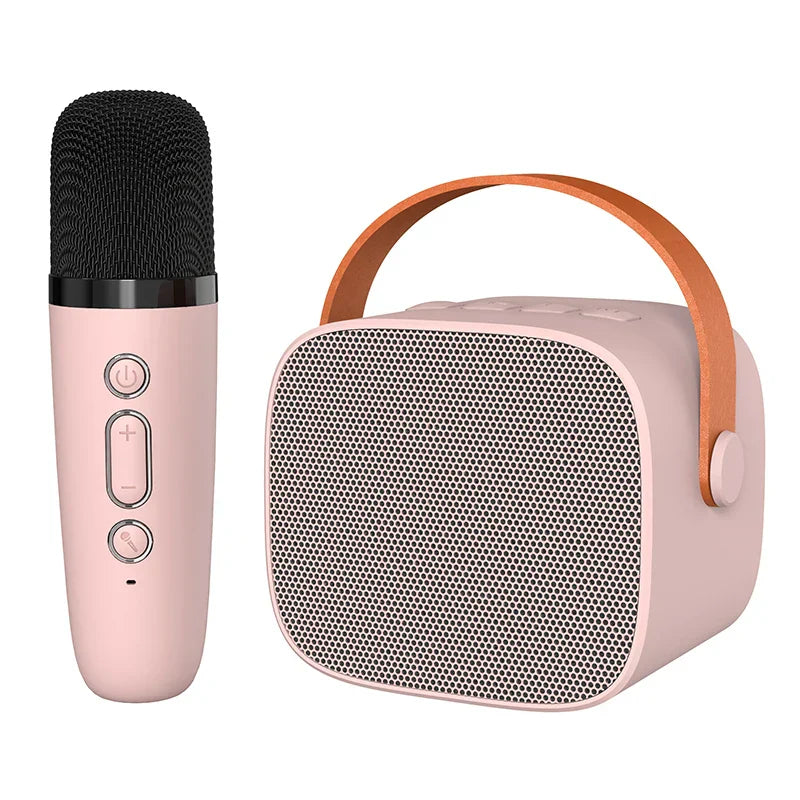 Pink wireless microphone and kids portable speaker karaoke machine with black mesh grille and leather handle for home party